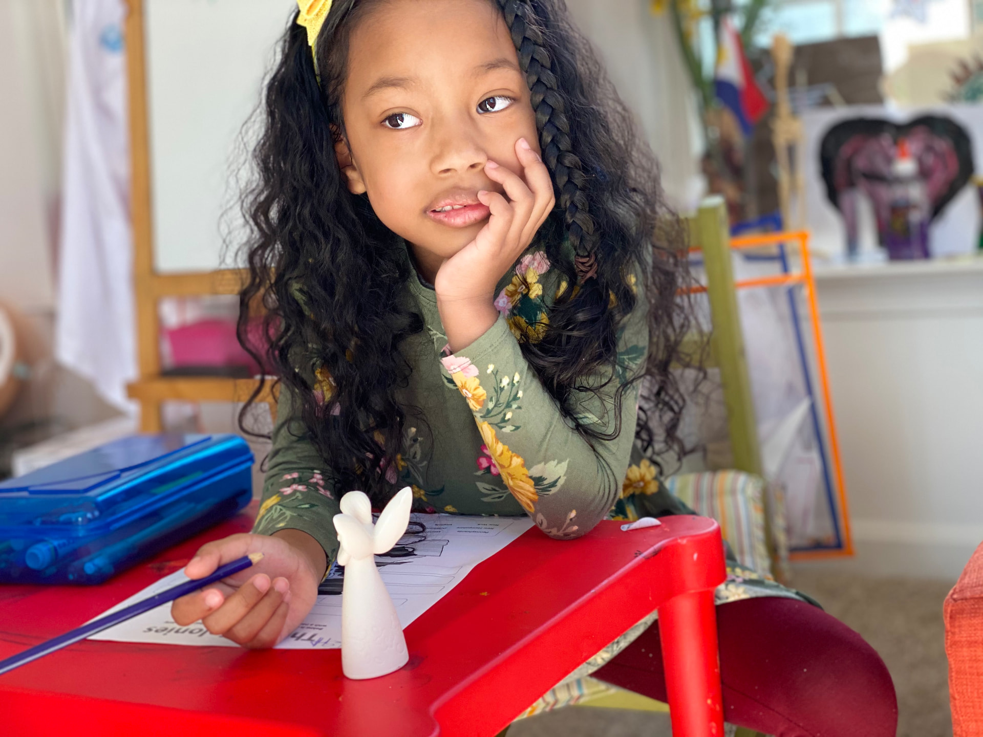 Ishara thinking at her desk while writing