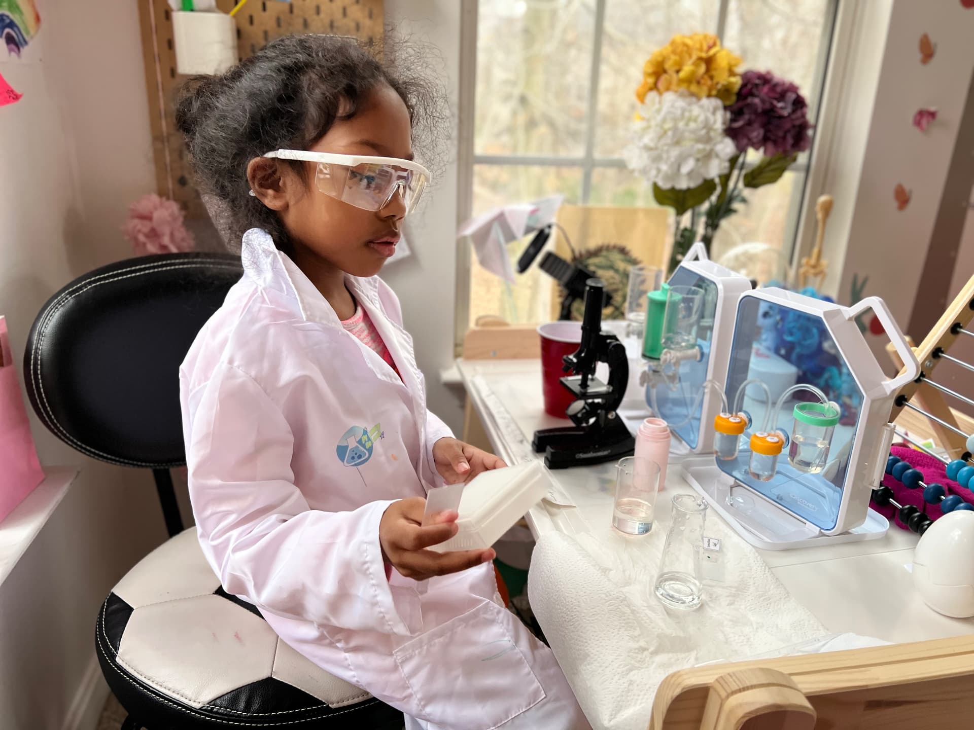 Ishara doing a science experiment at her lab table